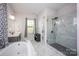 Elegant bathroom with a freestanding tub, glass-enclosed shower, and stylish fixtures for a modern and sophisticated look at 5051 Hyannis Ct, Matthews, NC 28104