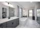 Luxurious bathroom with a soaking tub, dual vanities, and a glass-enclosed shower, creating a spa-like experience at 5051 Hyannis Ct, Matthews, NC 28104