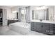 Spacious bathroom featuring a soaking tub with marble surround and dual sink vanities at 5051 Hyannis Ct, Matthews, NC 28104