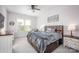 Cozy bedroom with a comfortable bed, neutral color scheme, and a ceiling fan for a relaxing atmosphere at 5051 Hyannis Ct, Matthews, NC 28104