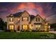 Stunning two-story brick home featuring a well-manicured lawn and beautiful landscaping at 5051 Hyannis Ct, Matthews, NC 28104