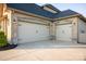 Spacious two-car garage boasts stone accents and updated lighting, enhancing the home's curb appeal at 5051 Hyannis Ct, Matthews, NC 28104
