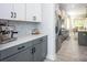 Stylish kitchen with white cabinets, stainless steel appliances, and a marble backsplash at 5051 Hyannis Ct, Matthews, NC 28104