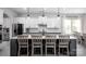 Modern kitchen featuring a large center island with seating, stainless appliances and white and gray cabinetry at 5051 Hyannis Ct, Matthews, NC 28104