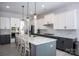 A modern kitchen with white and gray cabinets, quartz countertops, and stainless steel appliances is move-in ready at 5051 Hyannis Ct, Matthews, NC 28104