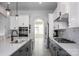 Beautiful kitchen with modern appliances, marble backsplash, quartz counters, and grey lower cabinets ready to be enjoyed at 5051 Hyannis Ct, Matthews, NC 28104