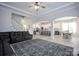 Spacious living room featuring a large rug, tray ceiling, fireplace, comfy sofa, and open floor plan at 5051 Hyannis Ct, Matthews, NC 28104