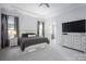 Spacious main bedroom with a tray ceiling, neutral tones, and a large dresser, offering a serene retreat at 5051 Hyannis Ct, Matthews, NC 28104