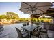 Outdoor living area with an outdoor kitchen, seating, dining space, pool, waterfall, and lounge area to relax at 5051 Hyannis Ct, Matthews, NC 28104