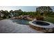 Custom in-ground pool with stone accents, waterfall, slide and spa providing a luxurious backyard retreat at 5051 Hyannis Ct, Matthews, NC 28104