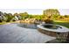 Beautiful backyard pool with a slide, waterfall feature, and a stone-surround hot tub for outdoor enjoyment at 5051 Hyannis Ct, Matthews, NC 28104