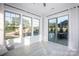 Bright sunroom with windows on three walls offering ample sunlight and amazing views of the pool and backyard at 5051 Hyannis Ct, Matthews, NC 28104