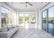Bright sunroom with lots of windows, a ceiling fan, and comfortable seating overlooking the pool and yard at 5051 Hyannis Ct, Matthews, NC 28104