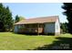 Back view of the house with porch overlooking a spacious green backyard at 5065 Gateway Dr, Claremont, NC 28610