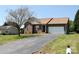 A well-kept lawn surrounds this cozy single-story home with a paved driveway and an attached garage at 5065 Gateway Dr, Claremont, NC 28610