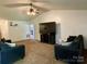 Bright living room featuring ceiling fan, TV, neutral paint, and comfortable seating arrangement at 5065 Gateway Dr, Claremont, NC 28610
