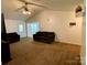 Bright living room featuring neutral paint, comfortable seating arrangement, and views to adjacent rooms at 5065 Gateway Dr, Claremont, NC 28610