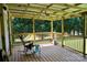 Covered back porch with wooden railings and a rocking chair to sit and relax at 5065 Gateway Dr, Claremont, NC 28610