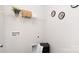 Practical laundry area with storage shelves, laundry basket, and easy access to utilities for efficient cleaning at 5116 Fireweed Ct, Dallas, NC 28034