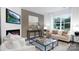 Bright living room with a fireplace, comfortable seating, and large windows with scenic views at 5116 Fireweed Ct, Dallas, NC 28034