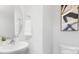 Bright powder room features a round mirror, white vanity, and modern art at 5116 Fireweed Ct, Dallas, NC 28034