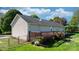 Exterior of home with wood deck, grassy lawn, and chain link fence surrounding the backyard at 5184 Swinging Bridge Rd, Conover, NC 28613