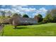 Grassy backyard featuring a deck, and fully fenced yard at 5184 Swinging Bridge Rd, Conover, NC 28613