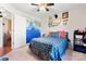 The spacious bedroom showcases a mountain mural, plaid bedspread, and curated wall decor at 5184 Swinging Bridge Rd, Conover, NC 28613