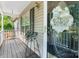 Inviting covered front porch with stylish decor and a glimpse of the home's exterior at 5184 Swinging Bridge Rd, Conover, NC 28613