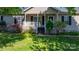 Inviting home exterior featuring a covered porch, manicured lawn, and charming landscaping at 5184 Swinging Bridge Rd, Conover, NC 28613