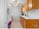 Bright kitchen with white appliances, wooden cabinetry, and tile flooring at 5184 Swinging Bridge Rd, Conover, NC 28613