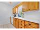 Well-lit kitchen featuring wooden cabinets, white countertops, and tile flooring at 5184 Swinging Bridge Rd, Conover, NC 28613