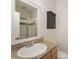 Bathroom features a single sink vanity, framed mirror, and sliding glass doors to tub shower at 562 New Bern Station Ct, Charlotte, NC 28209
