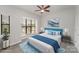 Bedroom features a large window, ceiling fan, and staged bed with blue accents at 562 New Bern Station Ct, Charlotte, NC 28209