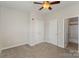 Open bedroom with multiple windows, a ceiling fan, closet, and an adjoining bathroom at 562 New Bern Station Ct, Charlotte, NC 28209