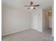 Bright bedroom featuring soft carpet, a ceiling fan and an entry to another room at 562 New Bern Station Ct, Charlotte, NC 28209