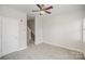 Neutral bedroom featuring a ceiling fan, carpeted floor, and staircase access at 562 New Bern Station Ct, Charlotte, NC 28209
