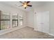 Spacious bedroom featuring a ceiling fan, three bright windows, and ample closet space at 562 New Bern Station Ct, Charlotte, NC 28209