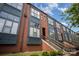 Charming townhome boasts brick facade and large windows, offering ample natural light and a welcoming appearance at 562 New Bern Station Ct, Charlotte, NC 28209