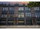 Townhome exterior featuring brick, modern windows, attached garages, and a rooftop patio against a colorful twilight sky at 562 New Bern Station Ct, Charlotte, NC 28209