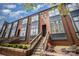 Attractive townhome with brick facade, stylish windows, and convenient front access, enhancing curb appeal at 562 New Bern Station Ct, Charlotte, NC 28209