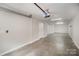 Spacious garage with concrete flooring, ample lighting, and an automatic door opener at 562 New Bern Station Ct, Charlotte, NC 28209