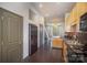 Functional kitchen space showcasing a black refrigerator, maple cabinets and hardwood floors at 562 New Bern Station Ct, Charlotte, NC 28209