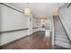 Spacious living room with hardwood floors, a staircase, and an open layout connecting to the dining area at 562 New Bern Station Ct, Charlotte, NC 28209