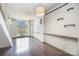 Bright living room featuring hardwood floors, large windows, and designer lighting fixtures at 562 New Bern Station Ct, Charlotte, NC 28209