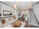 Cozy living room featuring a comfortable sofa, modern decor, and seamless transition to the dining area at 562 New Bern Station Ct, Charlotte, NC 28209