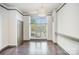 Spacious living room with hardwood floors, neutral paint, and a large window for natural light at 562 New Bern Station Ct, Charlotte, NC 28209