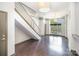 Open-concept living area featuring hardwood floors, a staircase, natural light, and modern design elements at 562 New Bern Station Ct, Charlotte, NC 28209