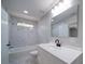 Modern bathroom showcasing new vanity with white countertop, tiled shower and tub with marble surround at 600 Burns St, Wadesboro, NC 28170