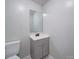 Half bathroom with modern toilet, cabinet, sink and mirror at 600 Burns St, Wadesboro, NC 28170